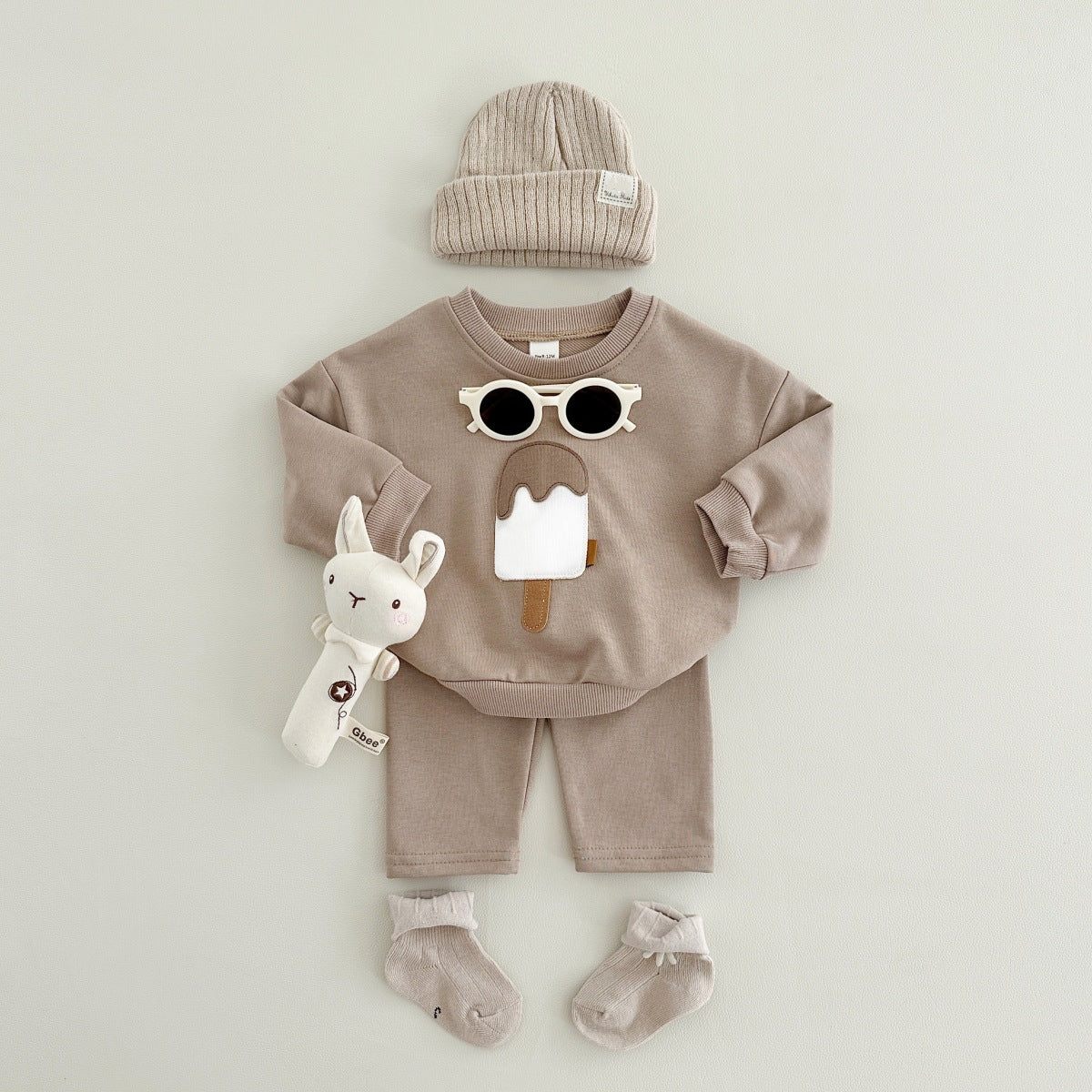 Baby outfit set with a shirt featuring a cute ice cream design and comfy pants, available in various colors for playful and comfortable everyday wear.